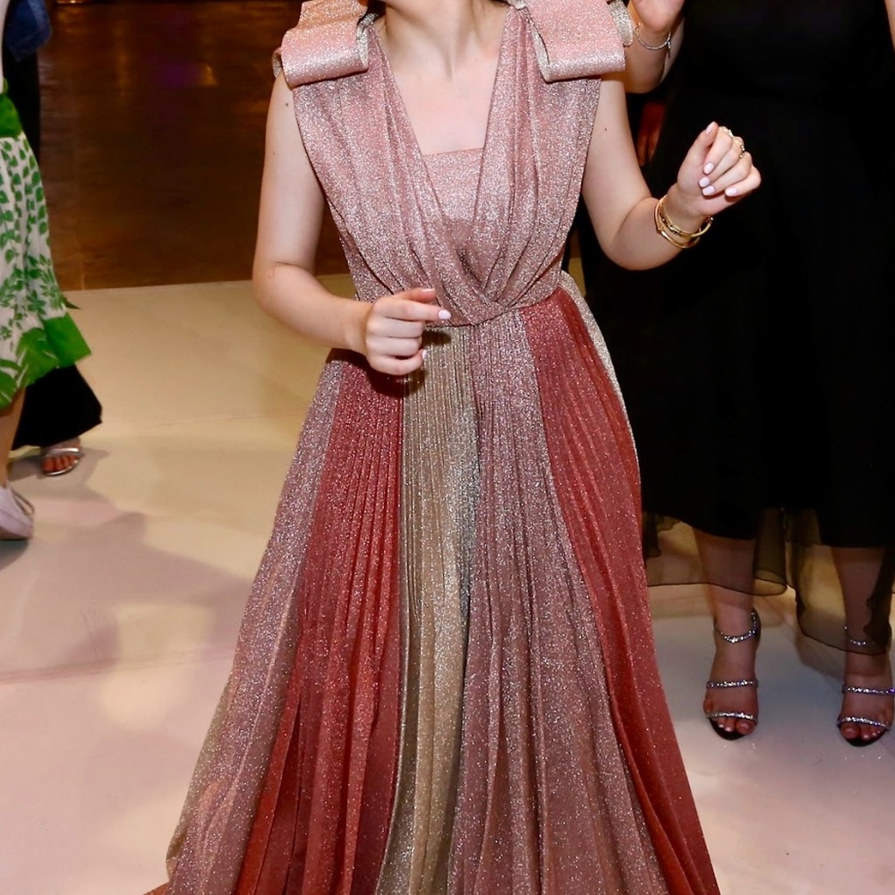 Custom made, sleeveless, floor length pleated gown, with bows on the shoulders.